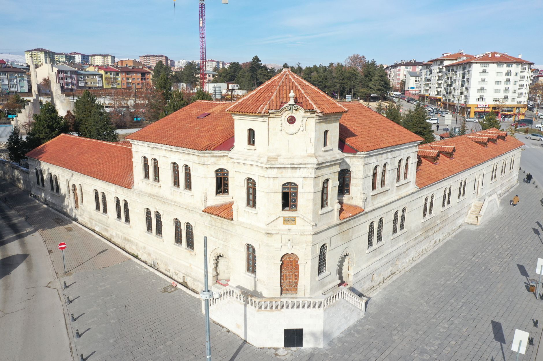 Aerial view of a historic stone building with red tile roofs in Sivas, Turkey, on a sunny day. — Affordable IVF Treatment Opt