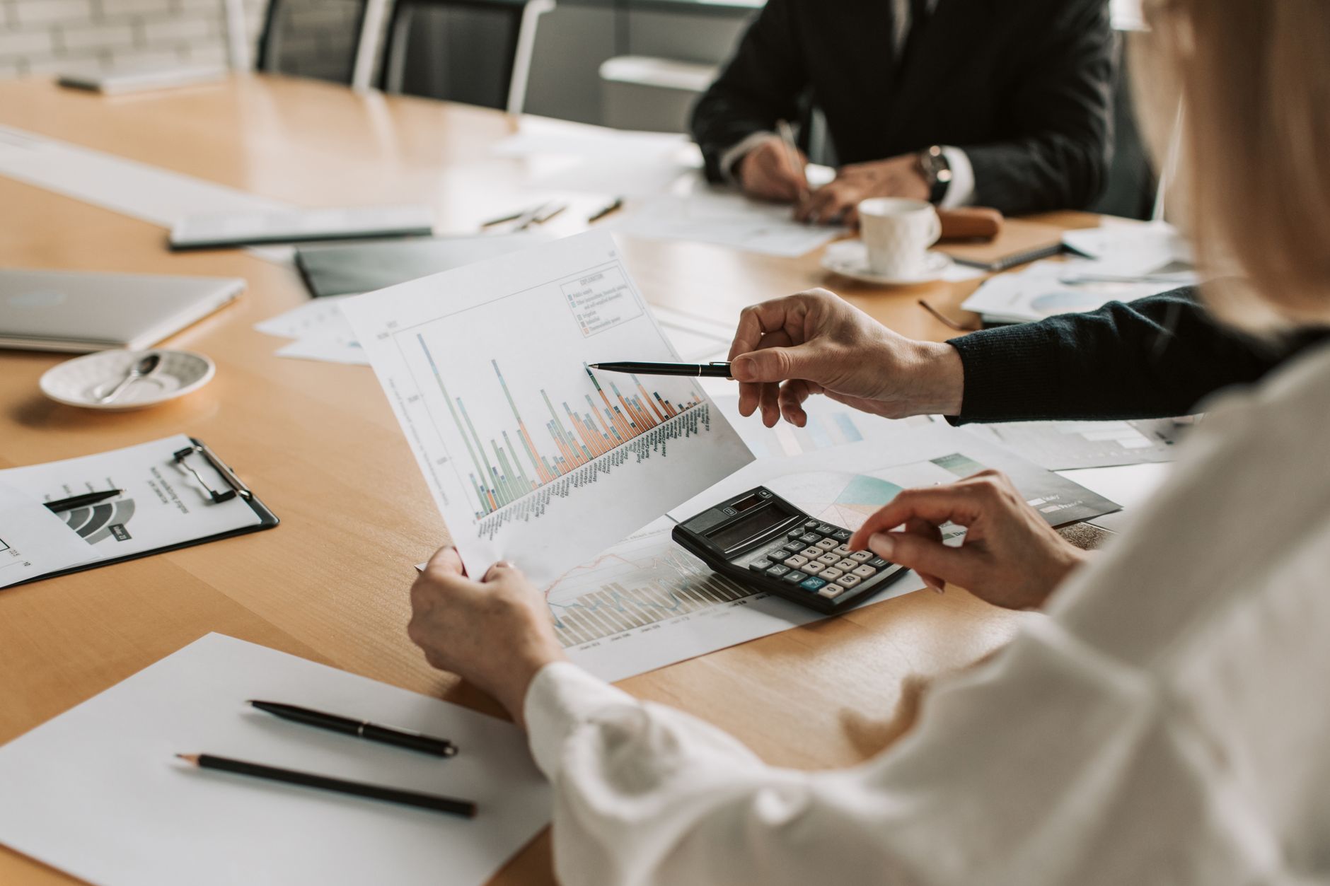 Professionals reviewing financial graphs and charts during a meeting. — Finding an Experienced and Knowledgeable DUI Attorney