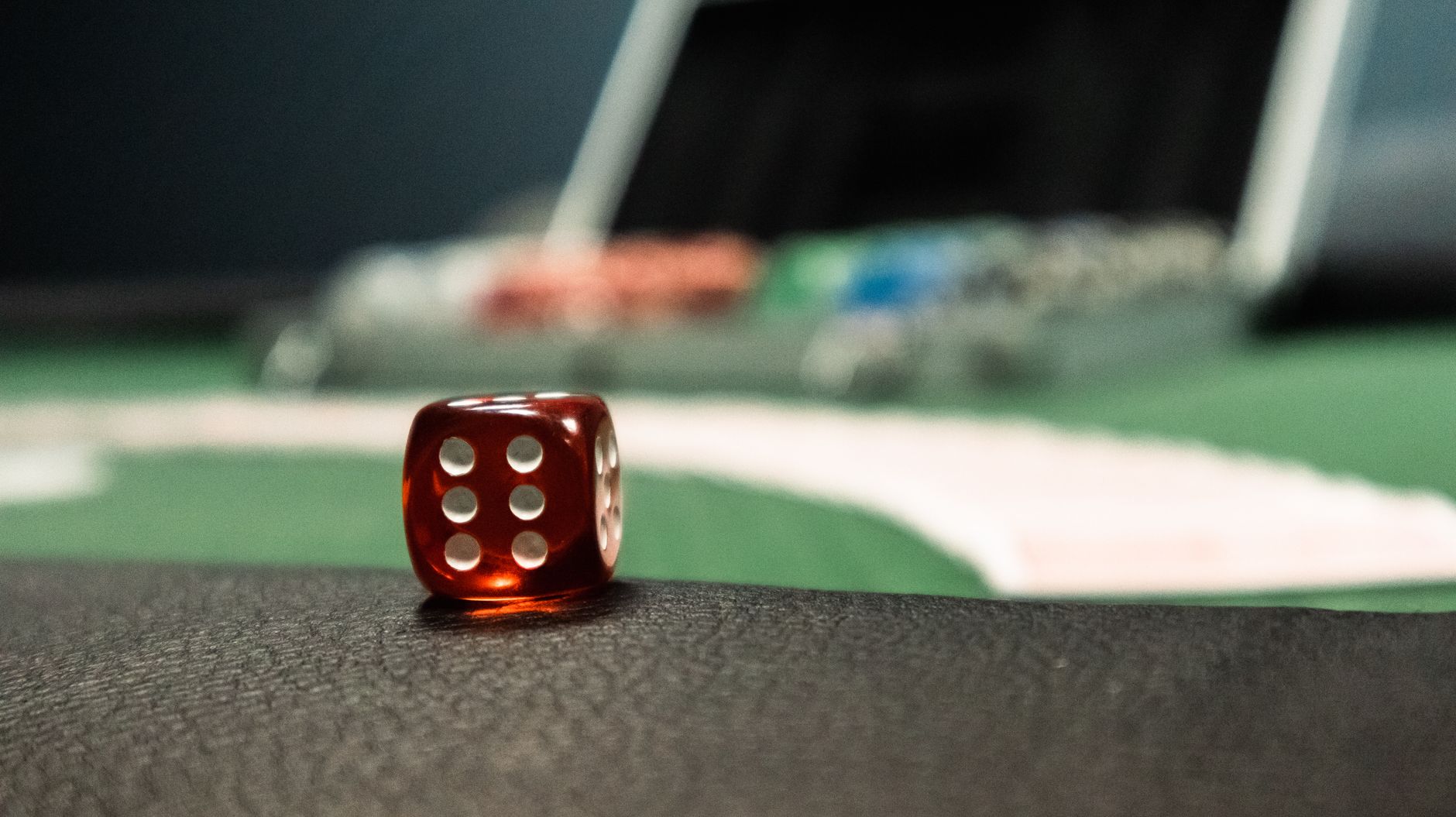 A close-up of a red dice on a casino table, evoking a sense of gambling excitement. — Get To Know The Tips For GClub