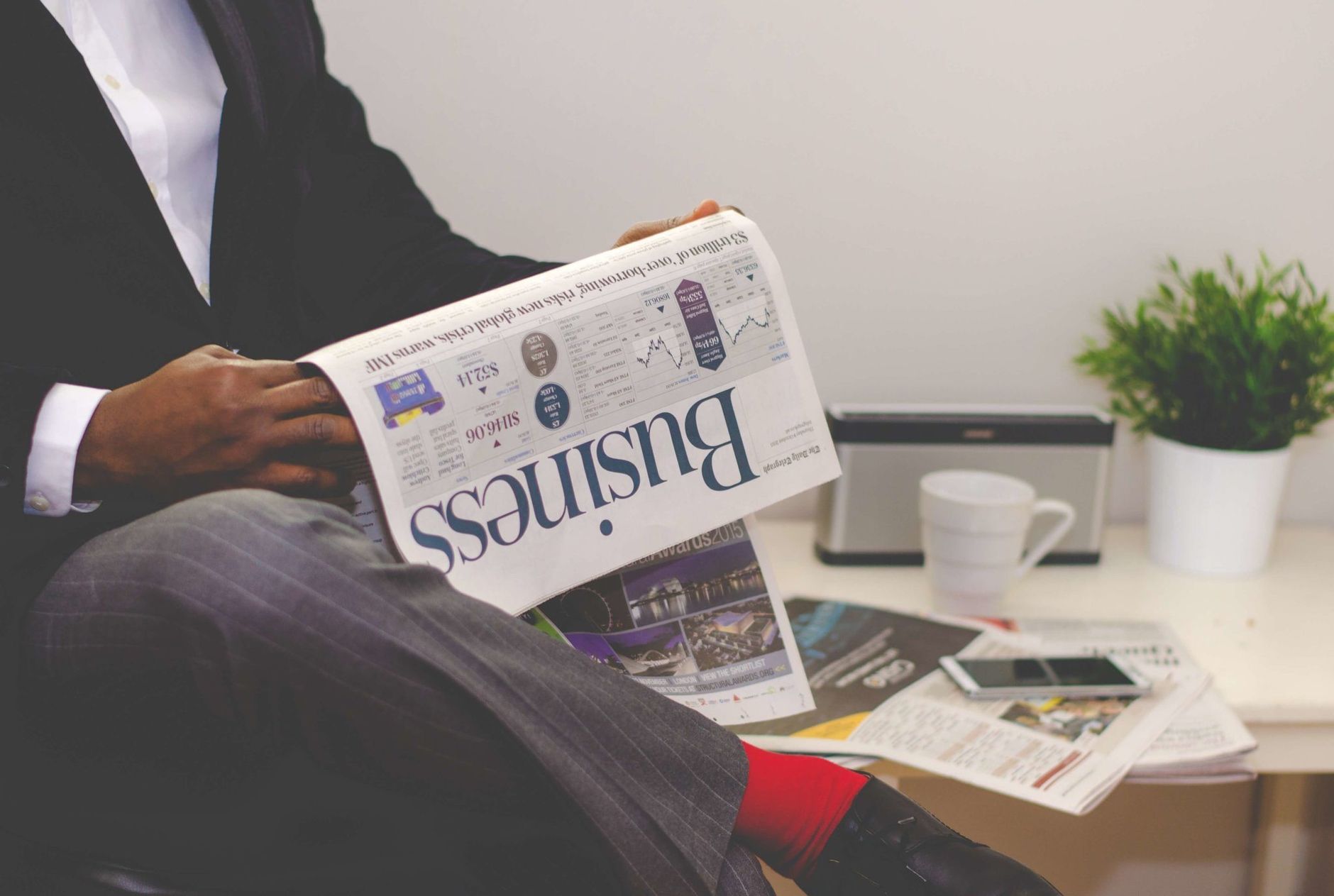 Businessman reading a financial newspaper at a desk, highlighting finance and commerce theme. — How to Buy a Star and Name It