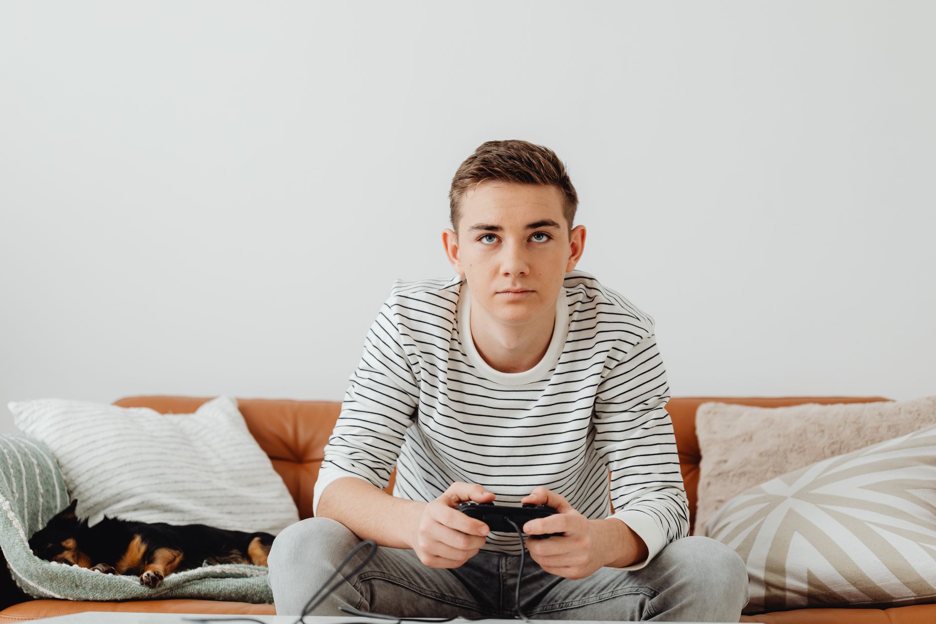 Teen boy intensely focused on video games at home, relaxing on a couch. — How to Make the Most of Your Time at Falcon Vegas C