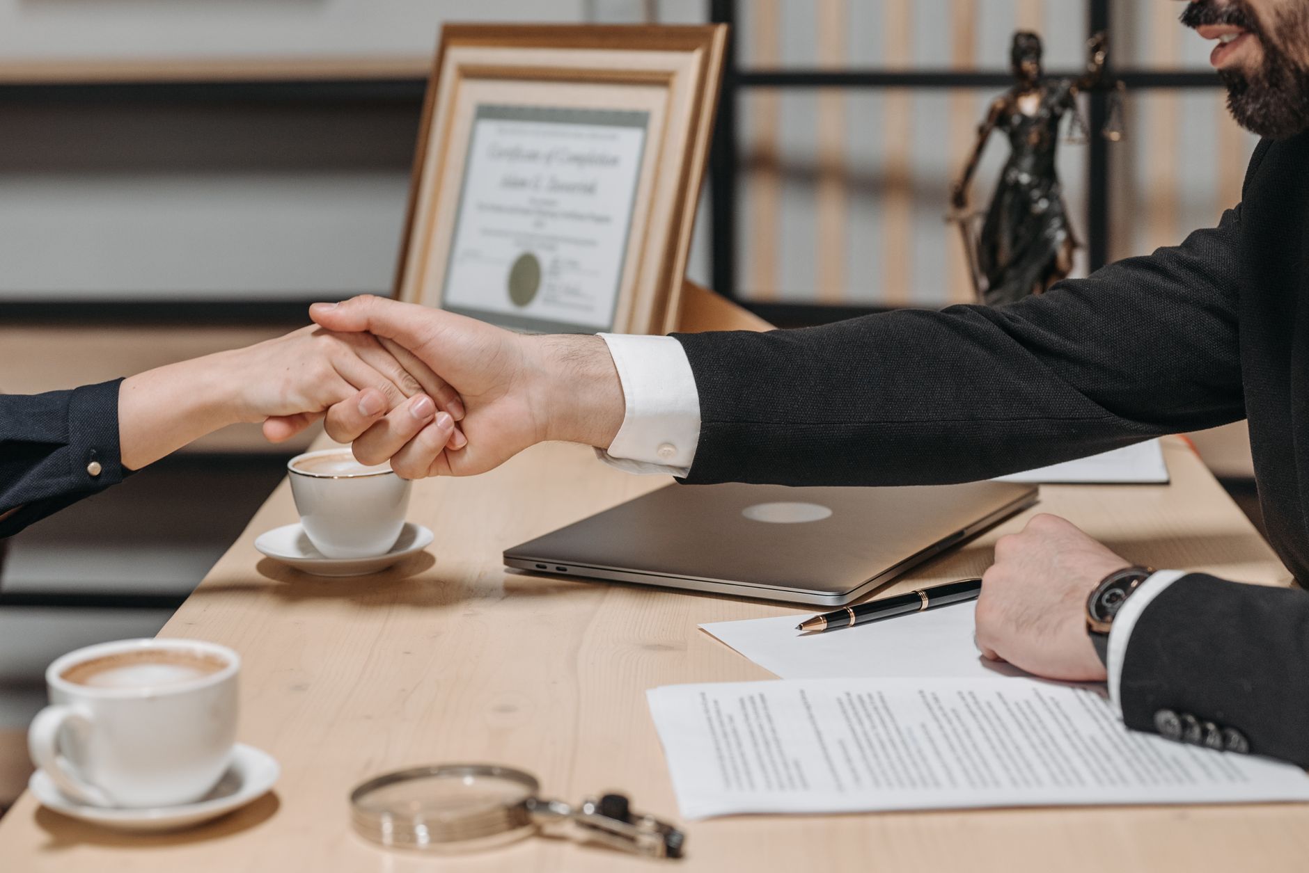 A formal handshake over a business contract in a corporate office setting. — Importance of Seeking Medical Care Immediately A