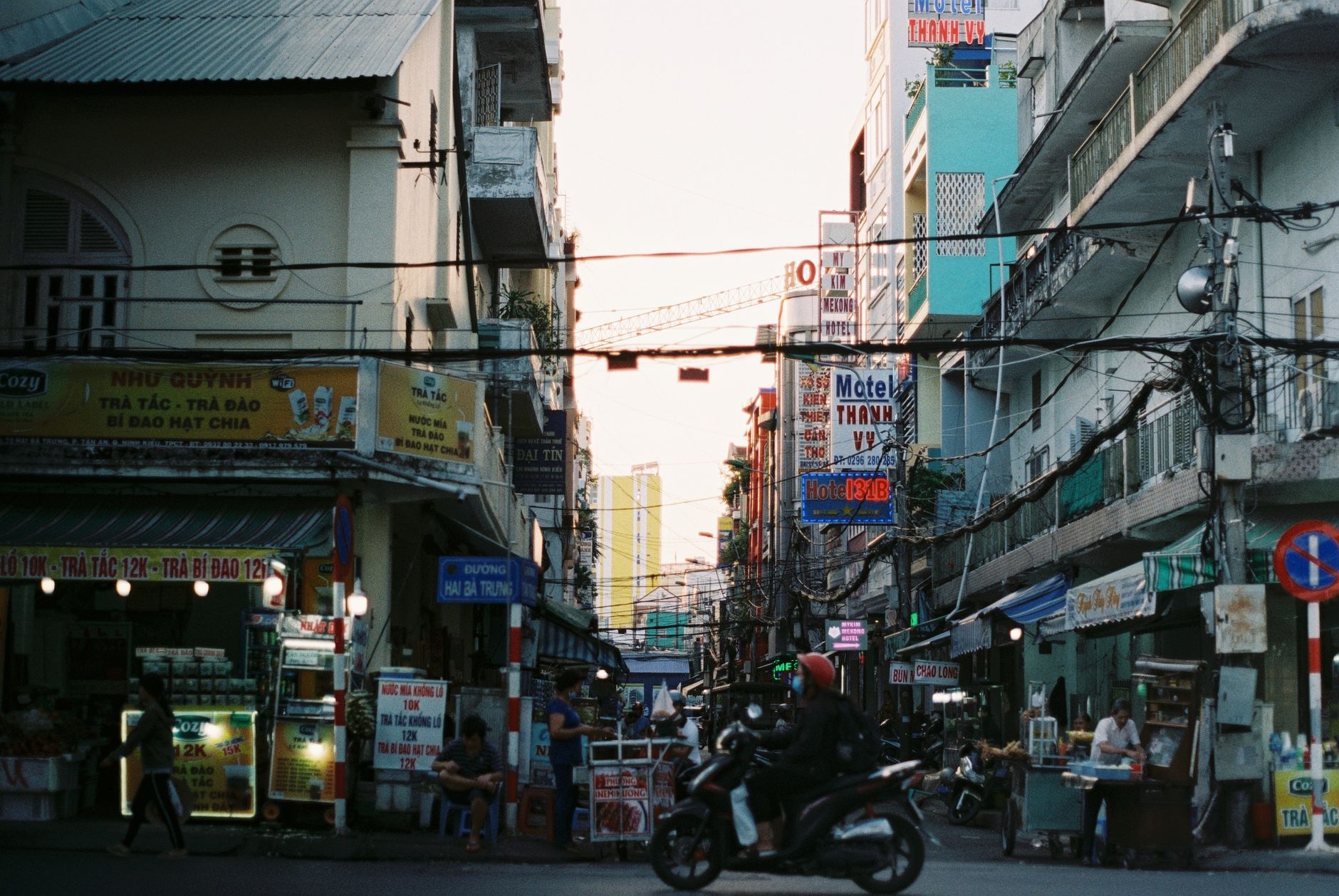 Colorful busy street scene in Cần Thơ, Vietnam with vibrant signs and people. — Joseph Samuels Islet: A Sanctuary for Marine