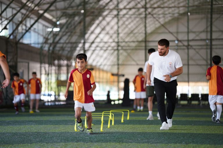 Energetic indoor soccer training with kids and coach, focusing on agility and teamwork. — Nine Casino : une oasis de jeux pou