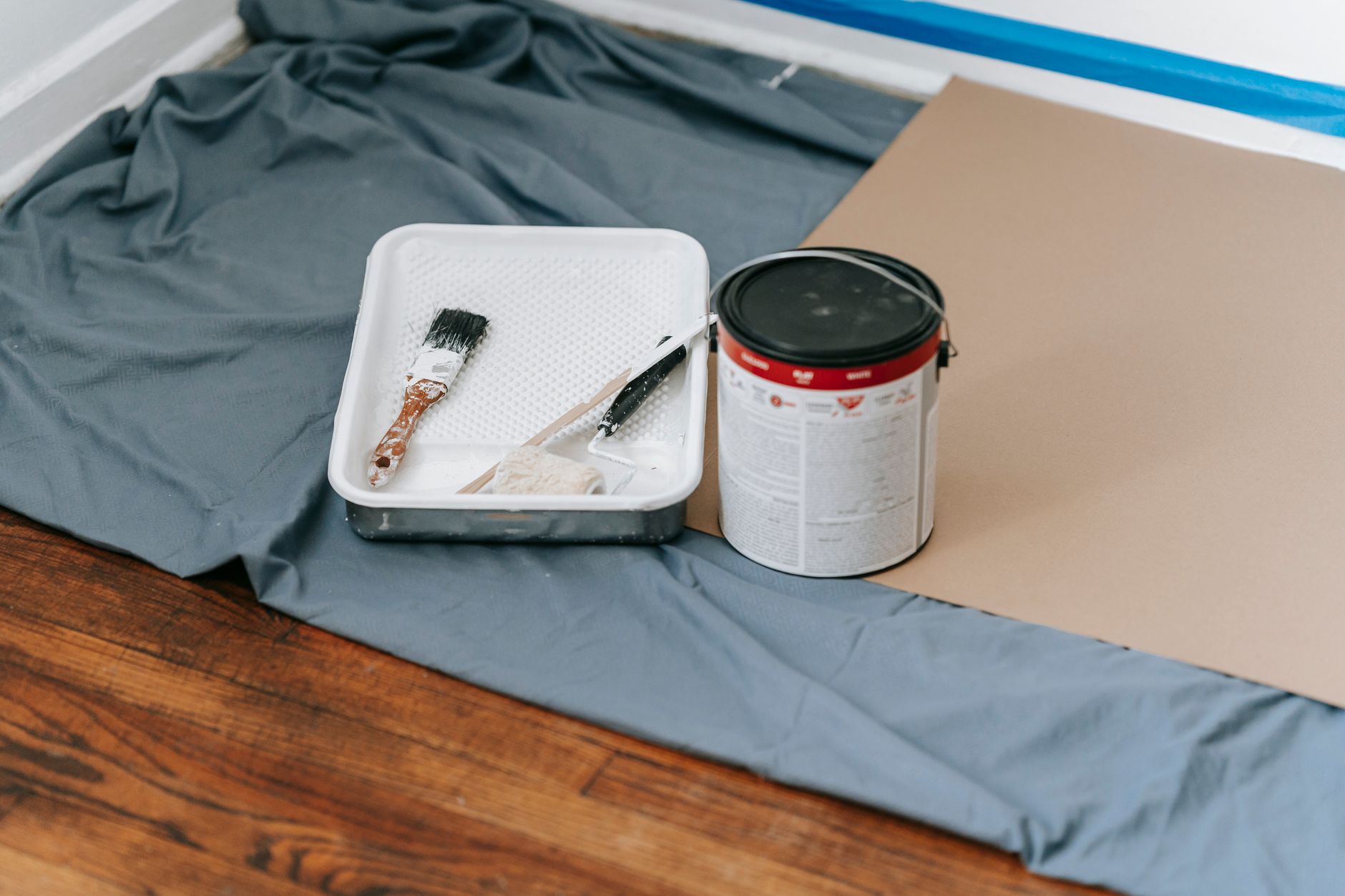 A collection of painting tools and materials prepared for a home renovation project indoors. — Persian rugs are costly but th