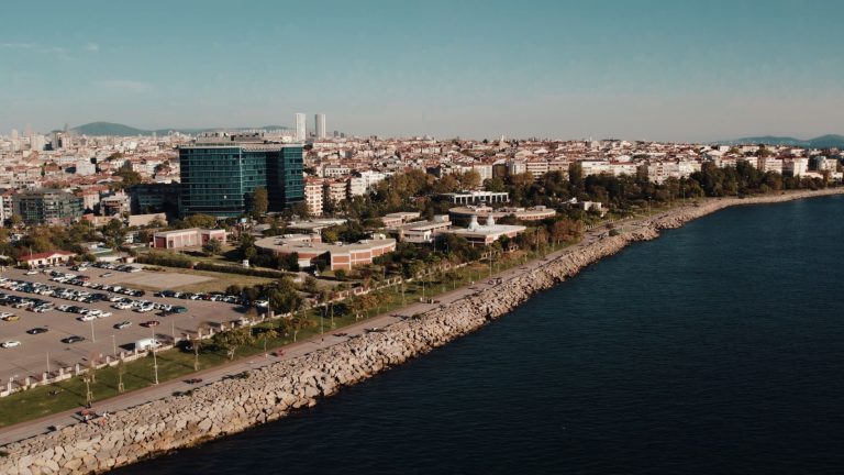 Aerial drone view of Istanbul's seaside cityscape featuring urban architecture and the Bosphorus shoreline. — Roman Casino év