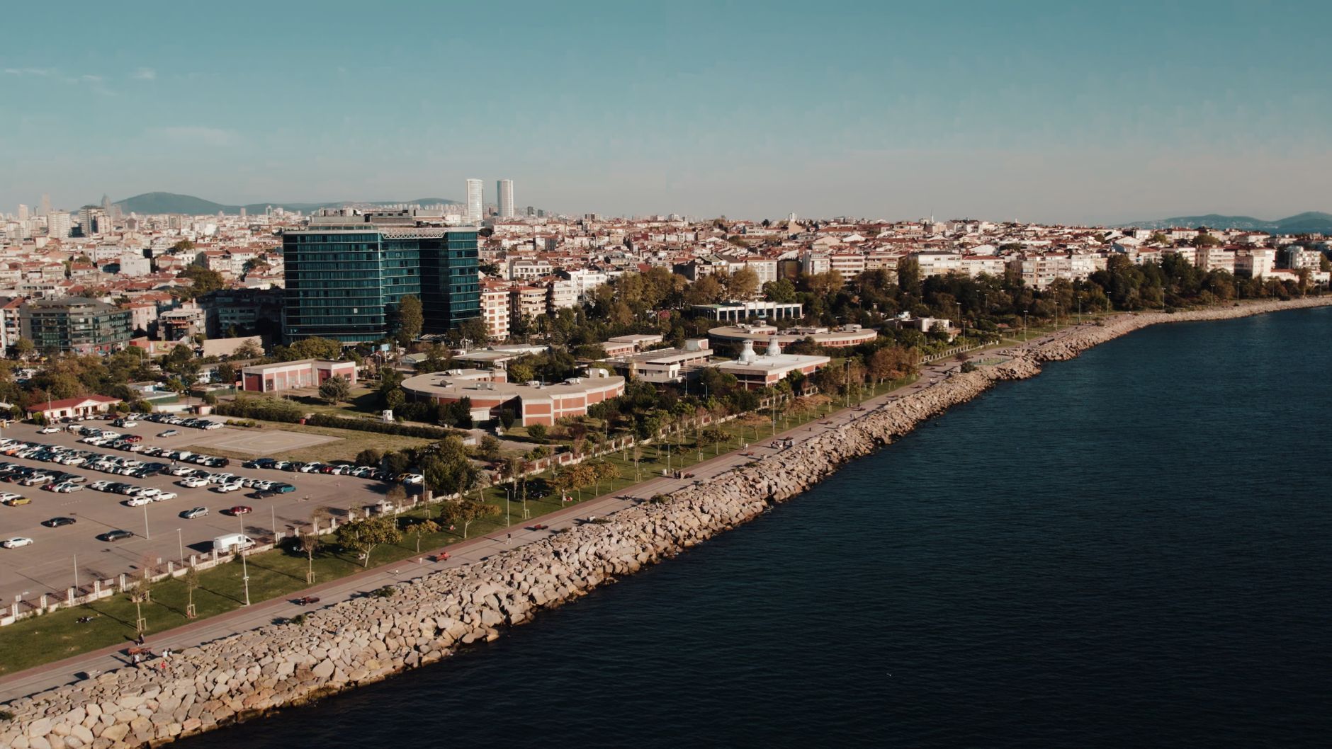 Aerial drone view of Istanbul's seaside cityscape featuring urban architecture and the Bosphorus shoreline. — Simplify Your P