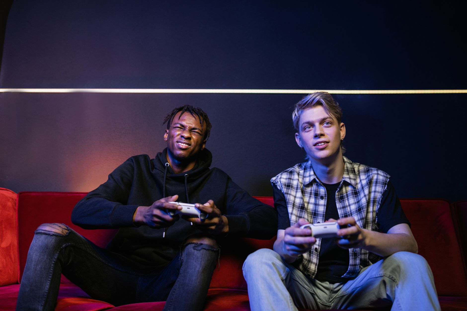 Two young men enjoying video games together on a couch, capturing leisure and friendship. — Some basic things you should lear