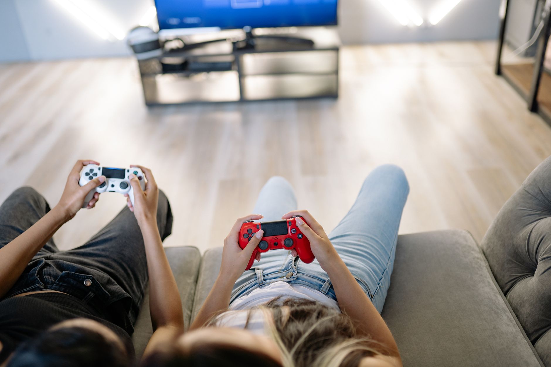 Two friends playing video games together indoors with game controllers. — Play Safe and Securely with an Online Casin