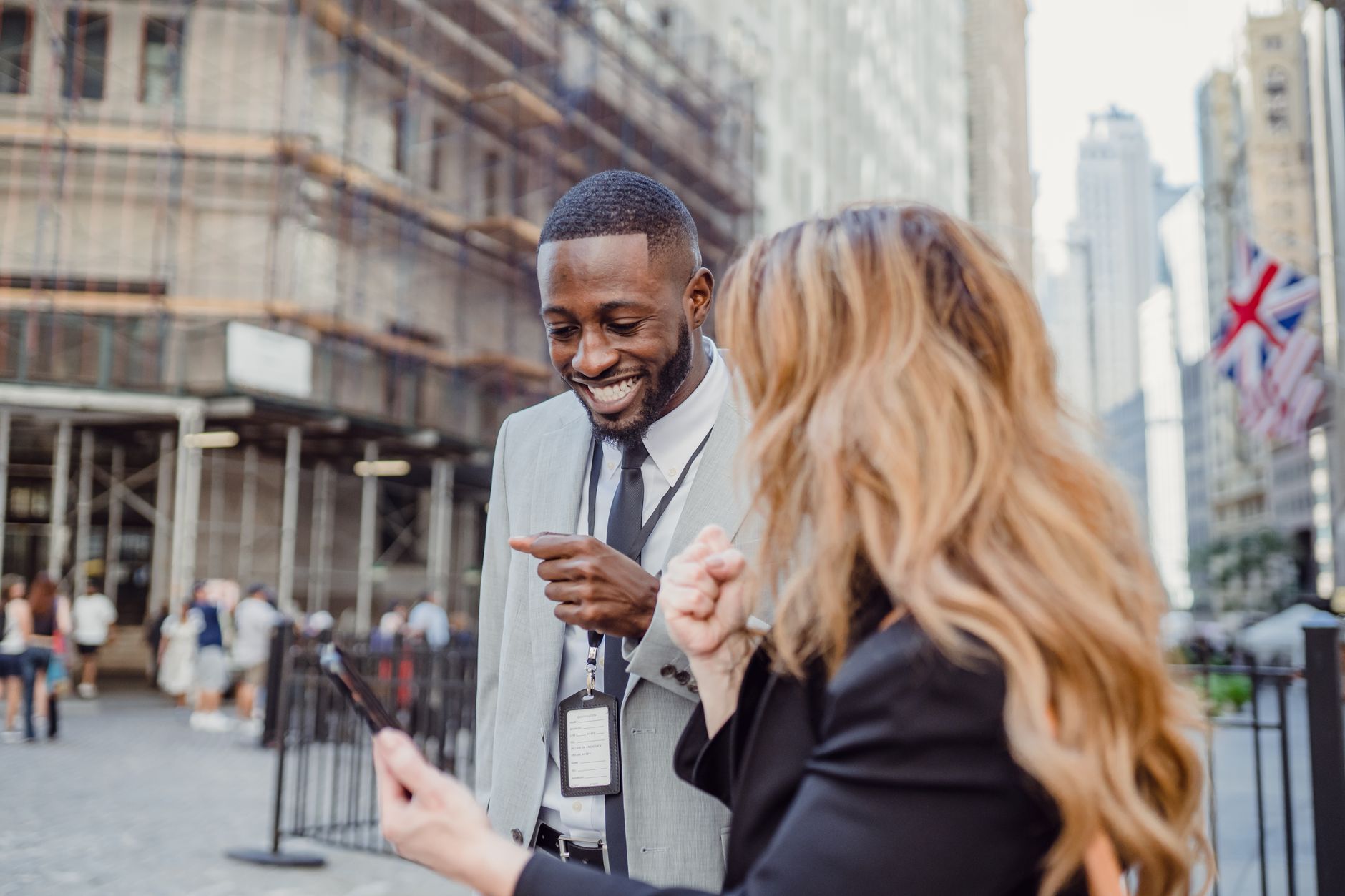 Two business professionals engage in lively conversation on an urban street, sharing insights. — The Top Tips To Buy