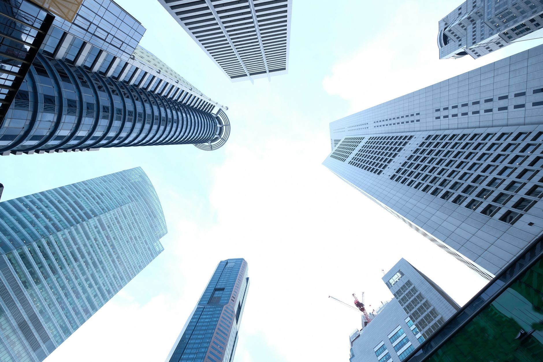 A striking upward view of various skyscrapers in an urban setting against a clear sky. — The Algorithmic Age: Embracing Artif