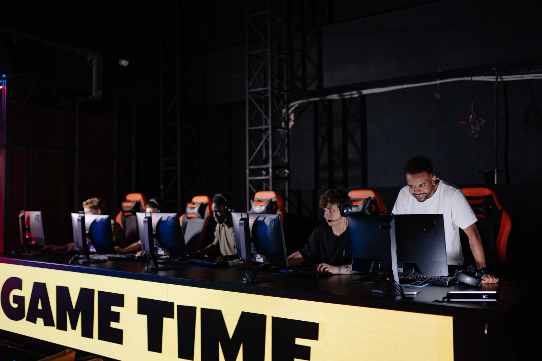 Esports team engaged in competitive gaming session indoors, showcasing teamwork and concentration. — The Future of Online Pok