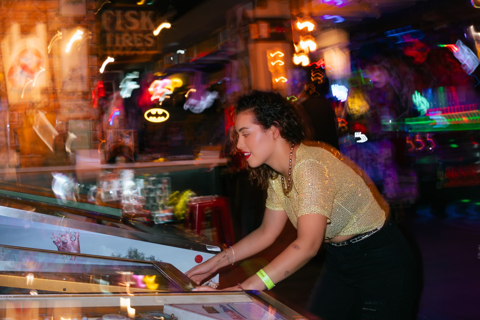 Young woman enjoying a night out playing pinball in an energetic arcade setting. — Top 4 stunning rewards that shouldn't be m