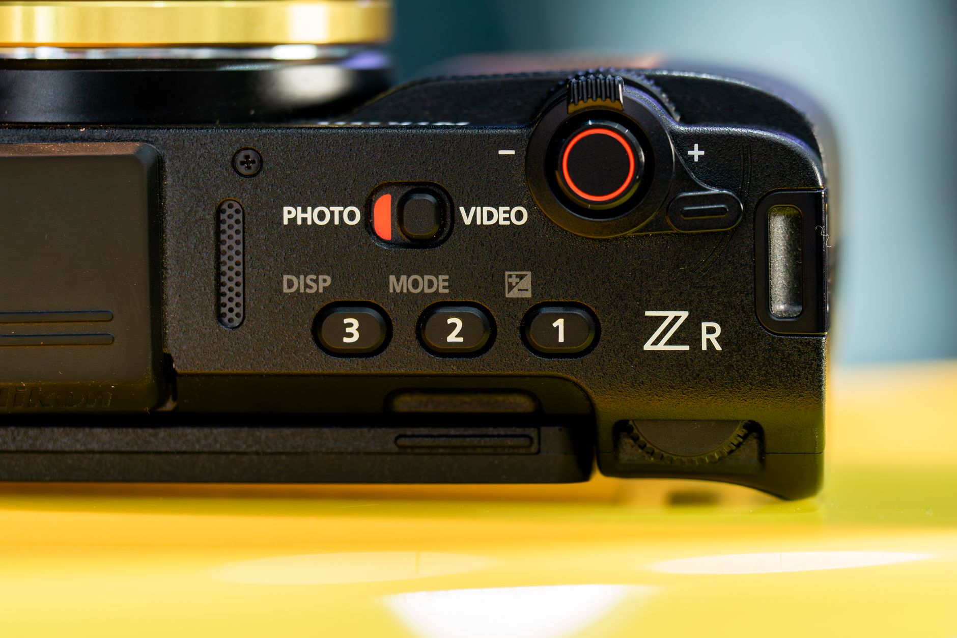 Detailed close-up of a camera's control interface featuring buttons and dials, emphasizing its design and functionality. — Wa