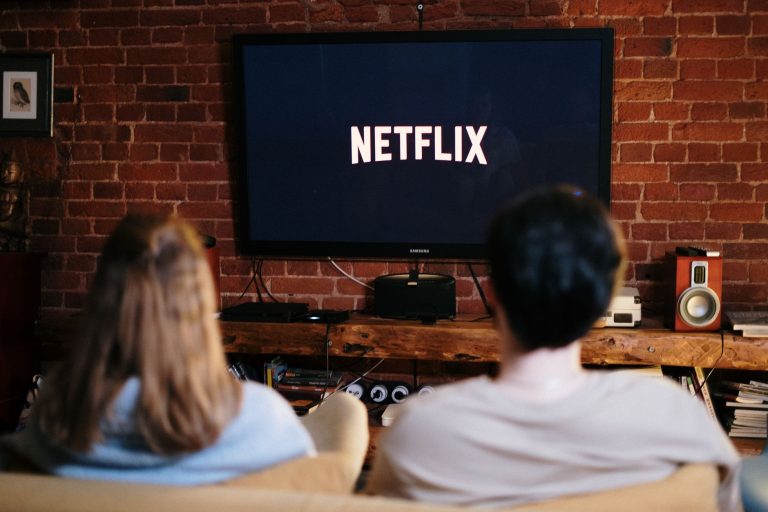 A couple relaxing and watching Netflix in a cozy living room setting. — Watch Boxing Live: Free Streaming Sites You Can't Mis