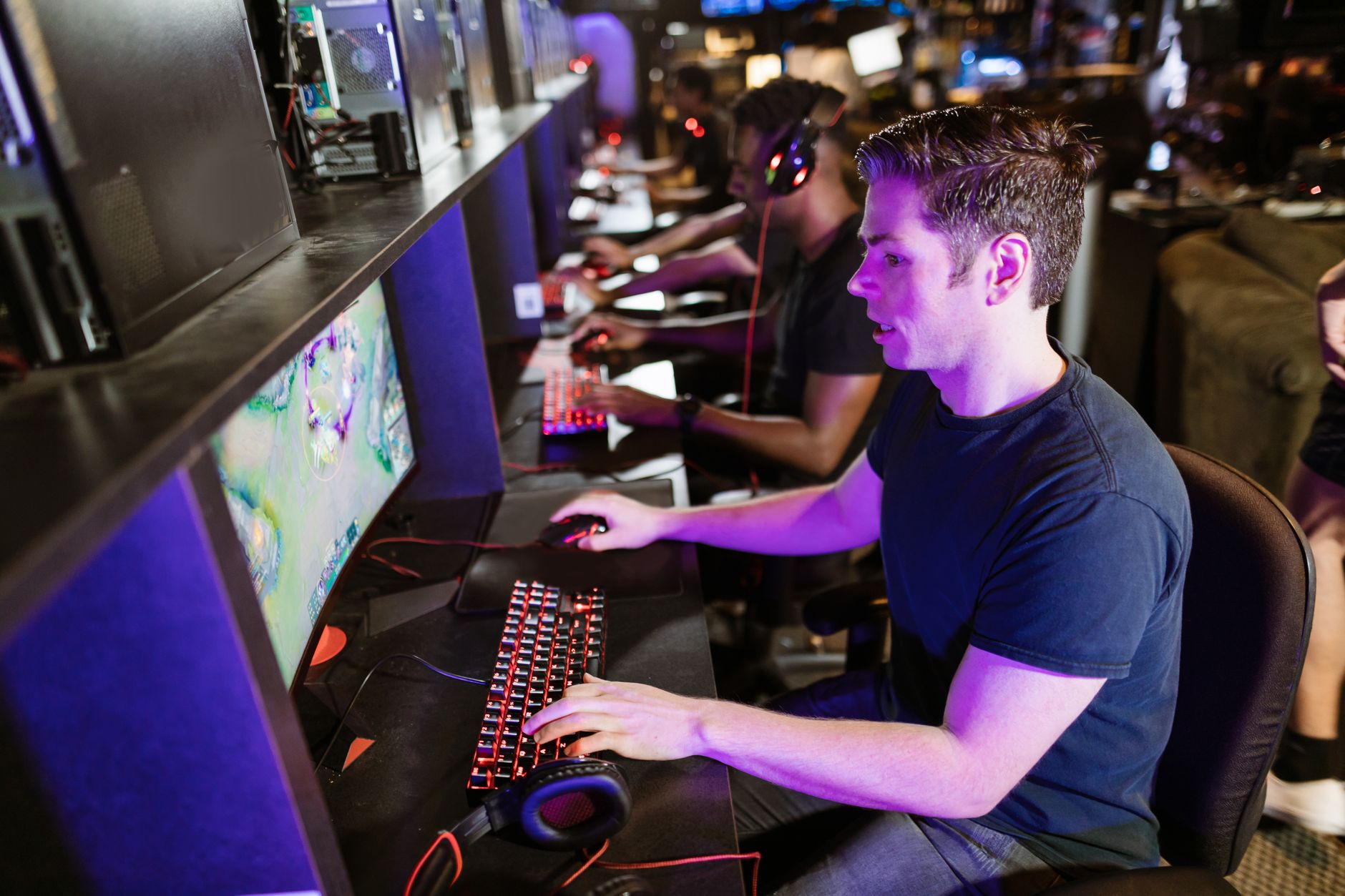 A group of men playing video games in an arcade with glowing gaming setups. — What to know prior to selecting a on line casin