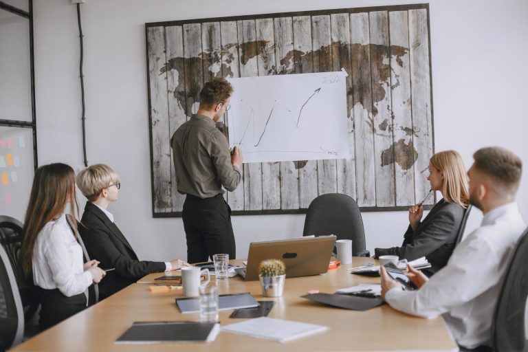 Group of business professionals discussing strategies with growth chart in conference room. — Why Tenants Take Action After R